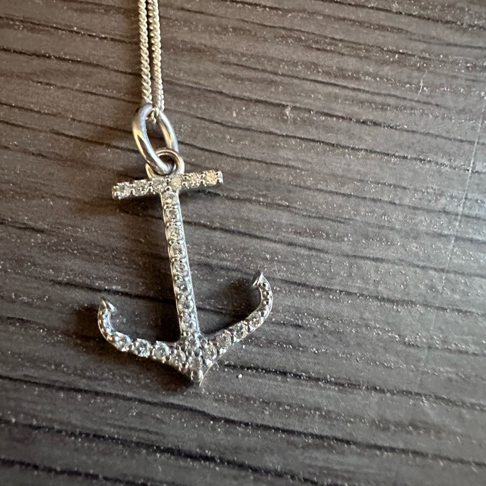 White gold and diamond anchor charm.